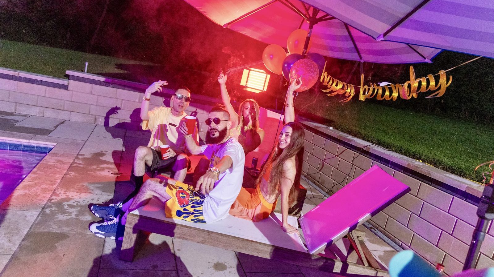 KING T and LUSS with friends under purple party lights