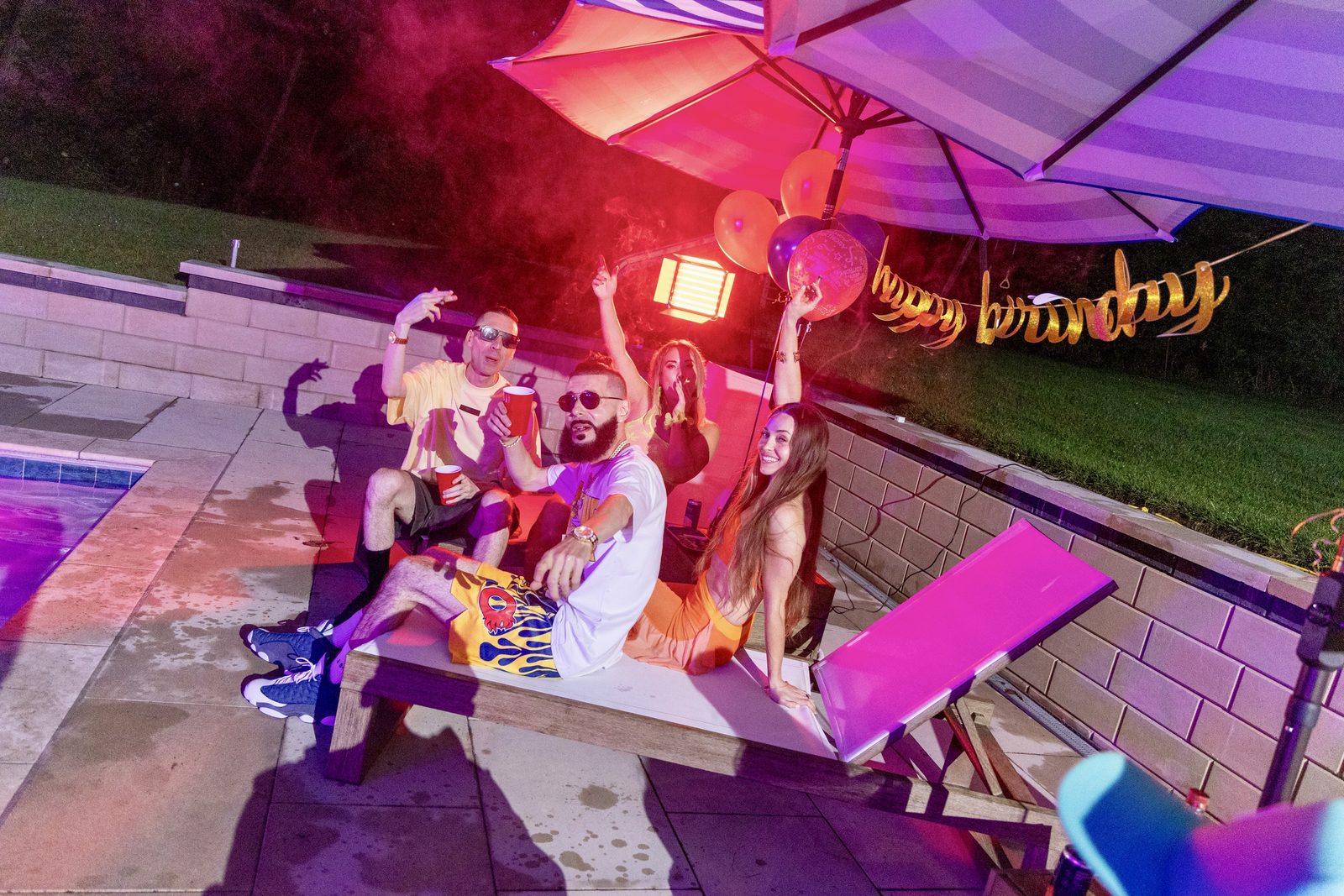 KING T and LUSS under a purple umbrella