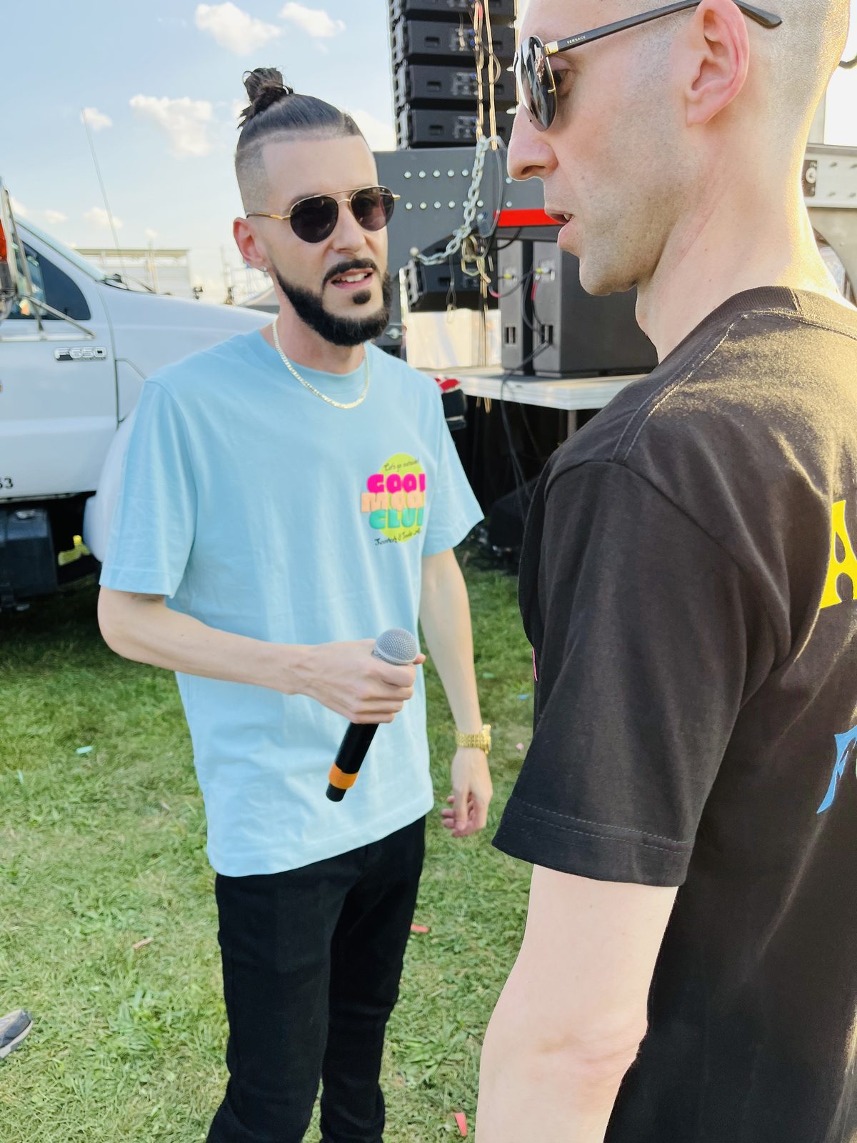 LUSS with a mic chatting backstage