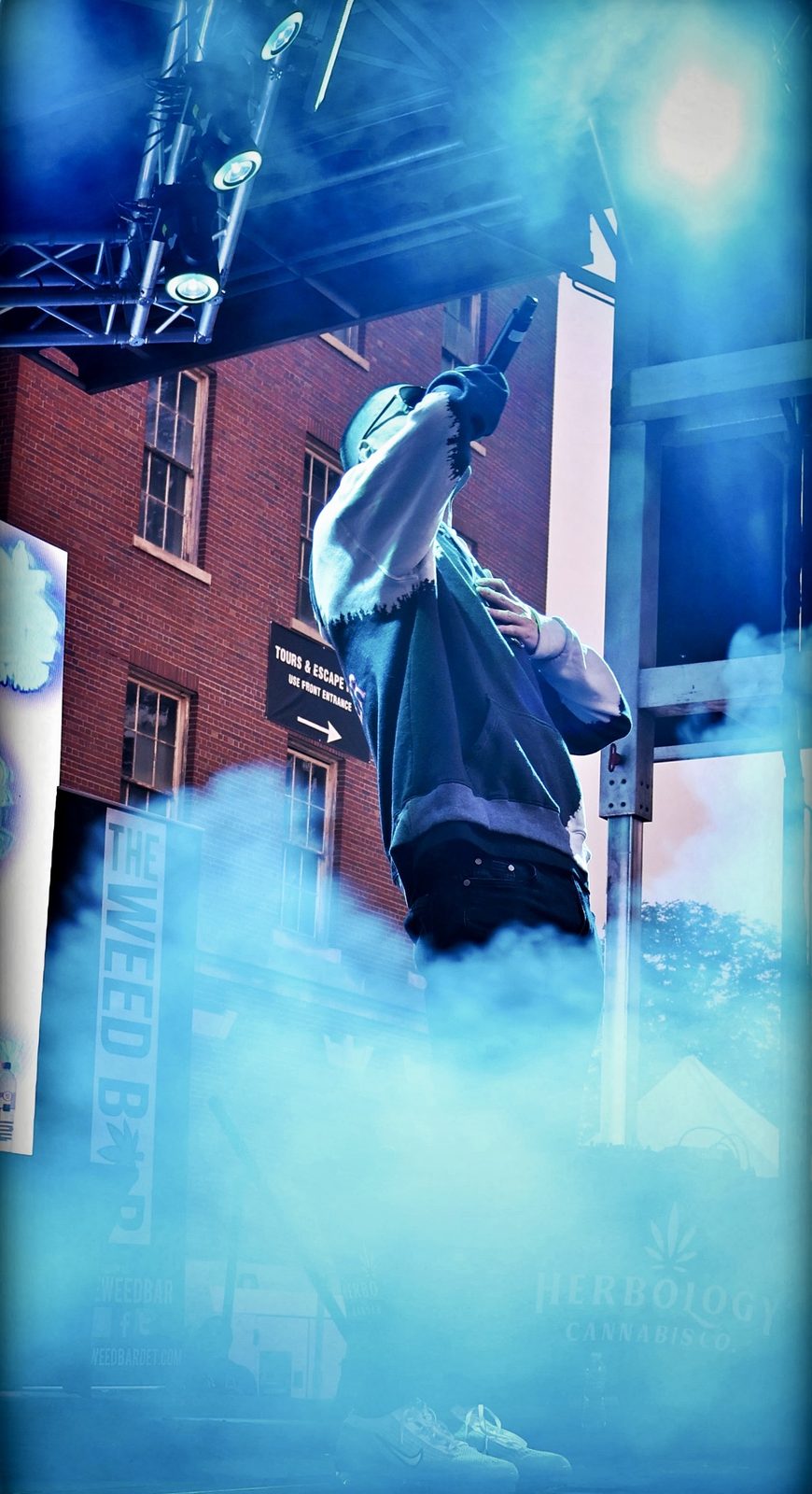 A TNL performer on stage in blue fog