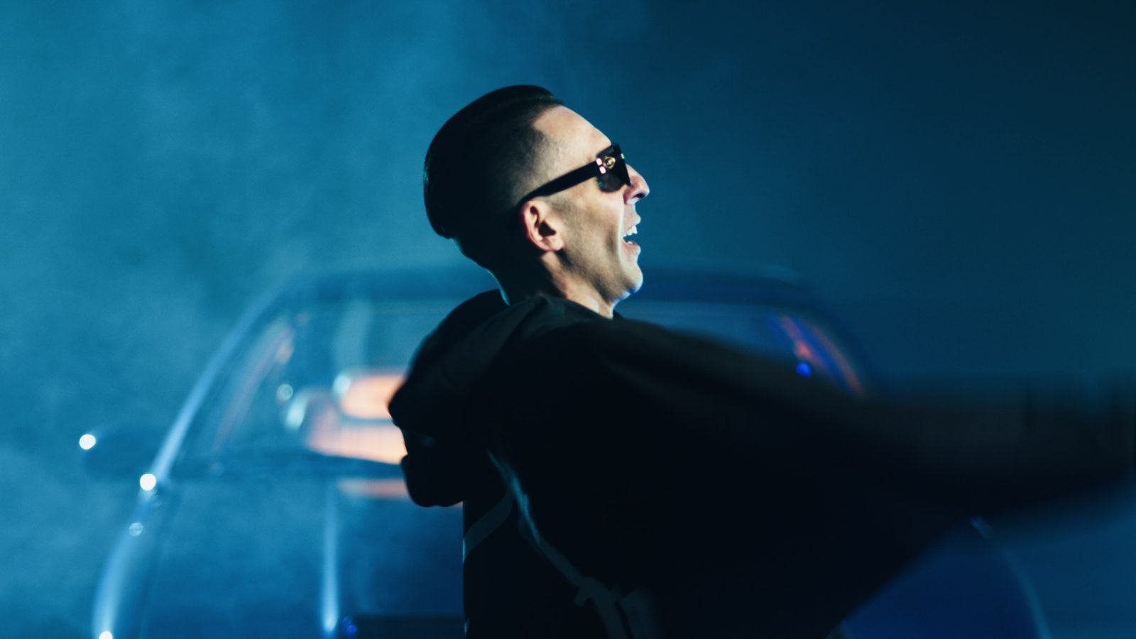 A profile in sunglasses in a music video